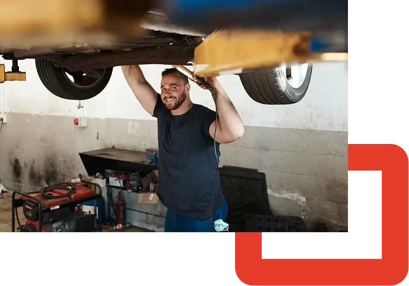 PAC-a mechanic working under a lifted car