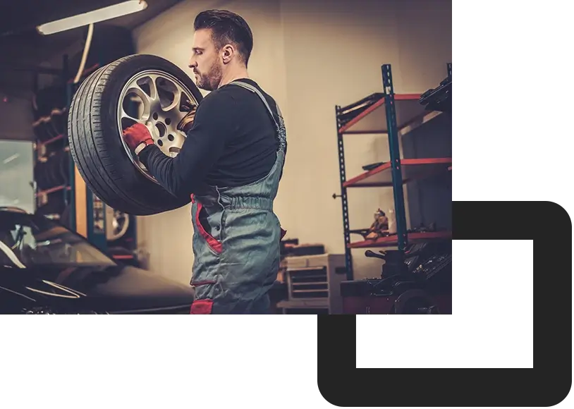 PAC-car mechanic balancing car wheel on balancer in auto repair service